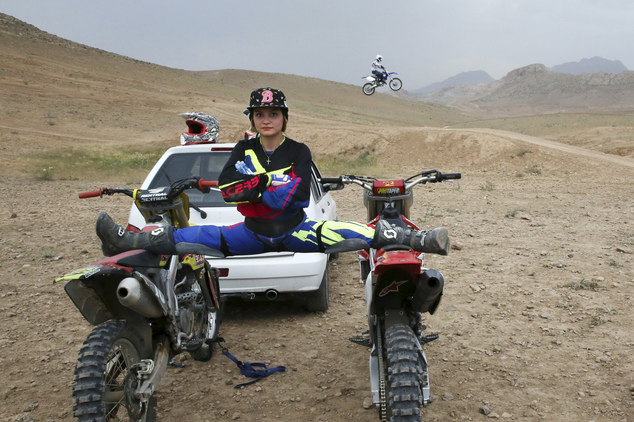 Iranian motocross rider Behnaz Shafiei poses for a photo as she stretches her legs