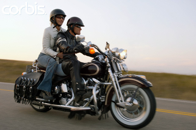 Couple riding motorcycle